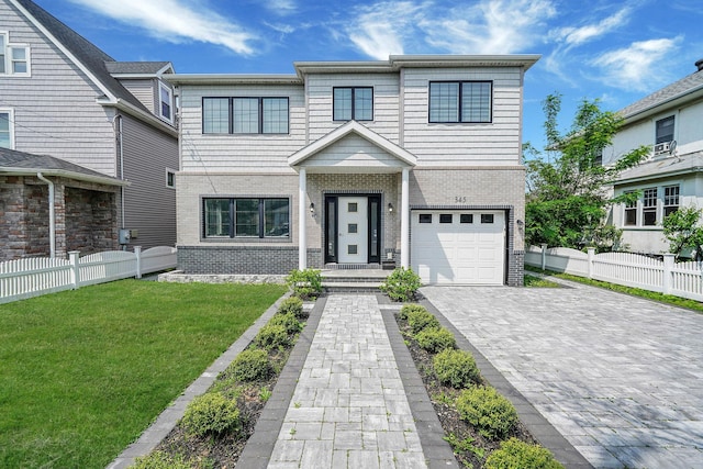 345 Washington Ave, Cedarhurst, NY 11516 - view of front facade featuring a garage, brick siding, and decorative driveway