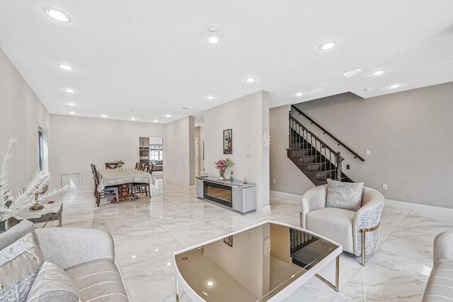 345 Washington Ave, Cedarhurst, NY 11516 - living room featuring light marble finish floors, recessed lighting, baseboards, and stairway