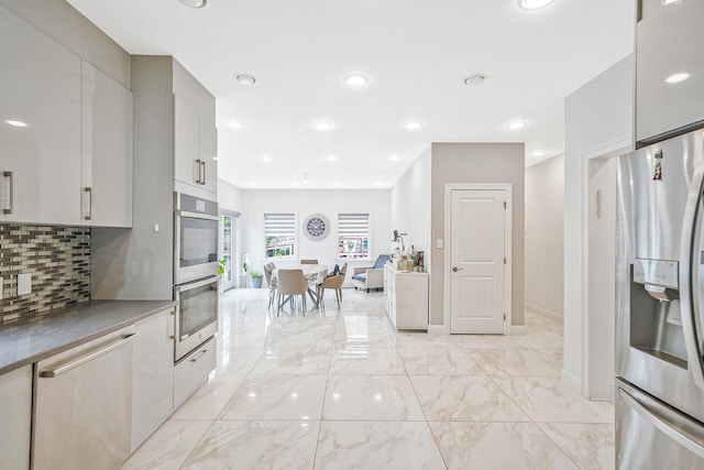 345 Washington Ave, Cedarhurst, NY 11516 - kitchen with stainless steel appliances, tasteful backsplash, light marble finish flooring, modern cabinets, and recessed lighting