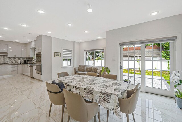 345 Washington Ave, Cedarhurst, NY 11516 - dining space featuring light marble finish floors and recessed lighting
