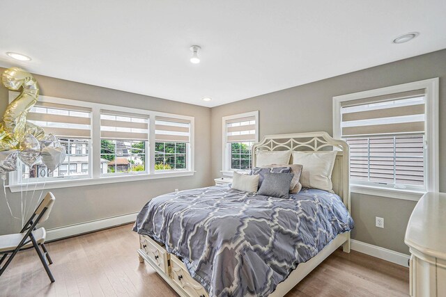 345 Washington Ave, Cedarhurst, NY 11516 - bedroom with baseboards and wood finished floors