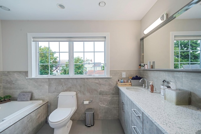 345 Washington Ave, Cedarhurst, NY 11516 - full bathroom featuring tile patterned floors, tile walls, vanity, a bath, and toilet