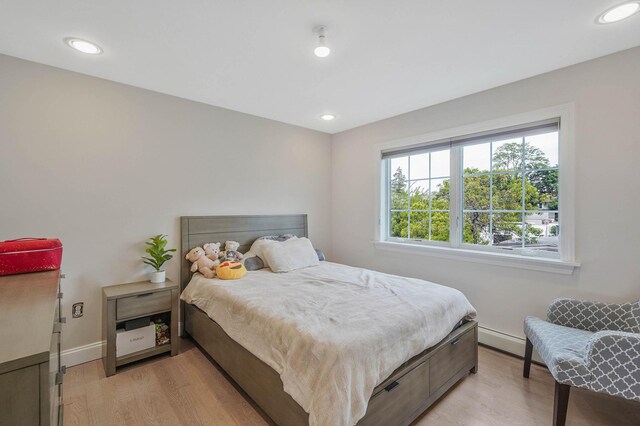 345 Washington Ave, Cedarhurst, NY 11516 - bedroom featuring baseboards, light wood-style floors, recessed lighting, and a baseboard radiator