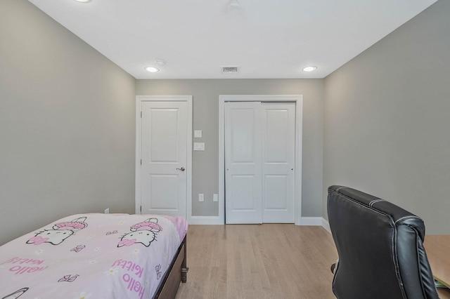 345 Washington Ave, Cedarhurst, NY 11516 - bedroom with light wood-style floors, a closet, and baseboards