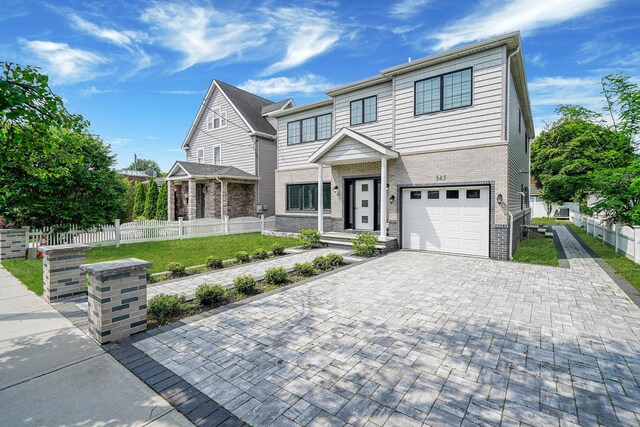 345 Washington Ave, Cedarhurst, NY 11516 - view of front of house with an attached garage, decorative driveway, and brick siding