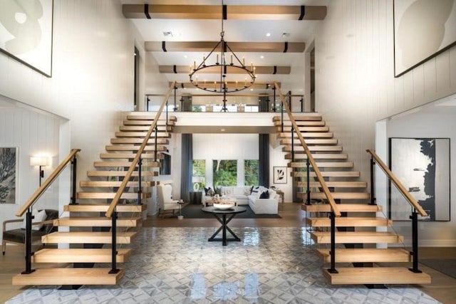 9 Sienna Ct, Dix Hills, NY 11746 - stairway with a high ceiling, a chandelier, and beam ceiling