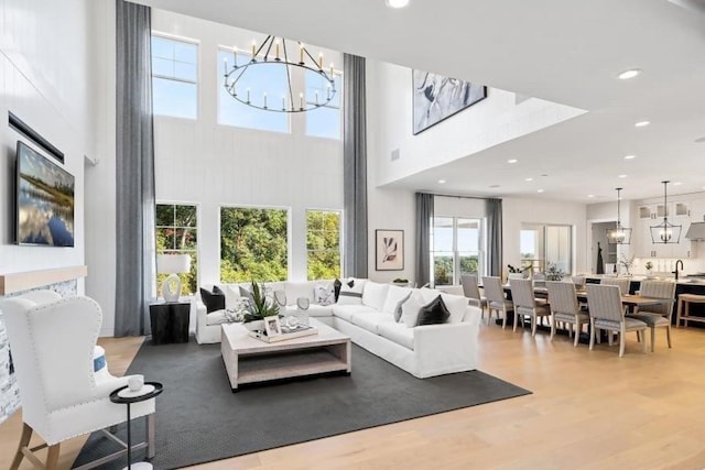 9 Sienna Ct, Dix Hills, NY 11746 - living area with a chandelier, a towering ceiling, light wood-type flooring, and recessed lighting