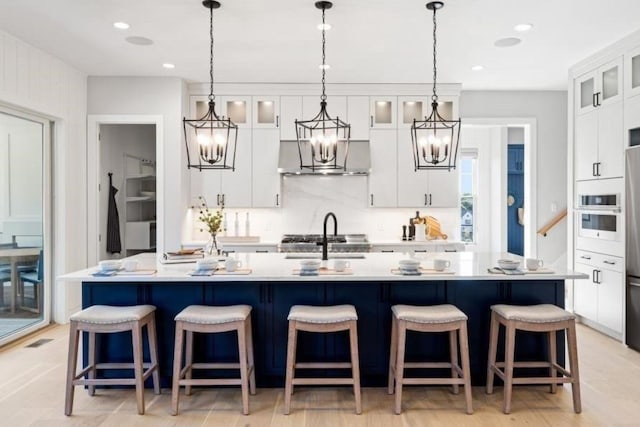 9 Sienna Ct, Dix Hills, NY 11746 - kitchen with a chandelier, light countertops, a kitchen island with sink, white cabinetry, and recessed lighting