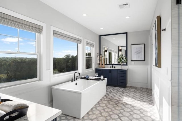 9 Sienna Ct, Dix Hills, NY 11746 - full bath with vanity, a freestanding tub, healthy amount of natural light, a wainscoted wall, and tile patterned floors