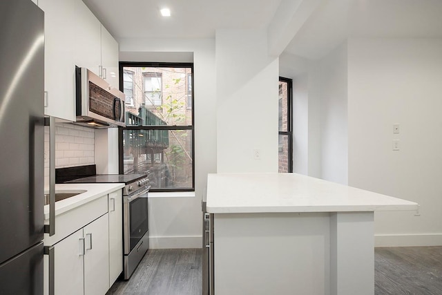 370 Rutland Rd, Brooklyn, NY 11225 - kitchen with stainless steel appliances, wood finished floors, tasteful backsplash, and light countertops