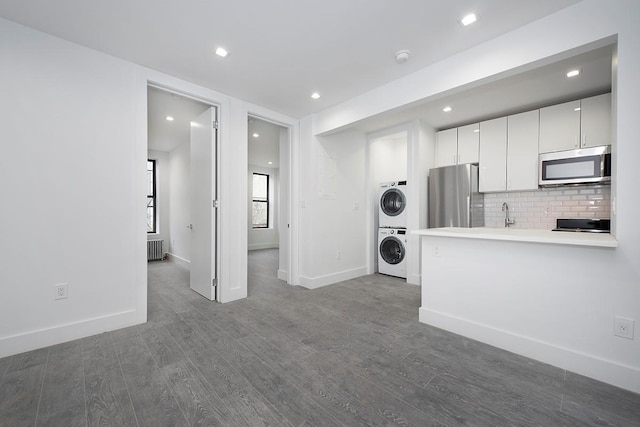 370 Rutland Rd, Brooklyn, NY 11225 - living area with stacked washer and clothes dryer, dark wood-type flooring, and recessed lighting