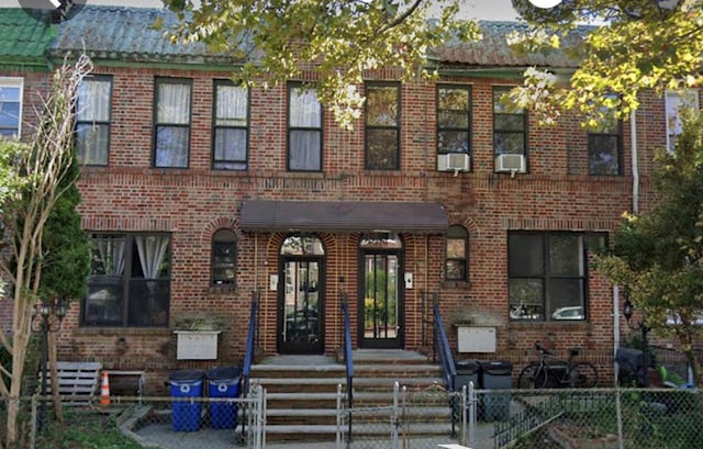 370 Rutland Rd, Brooklyn, NY 11225 - view of front facade featuring brick siding, a fenced front yard, and cooling unit