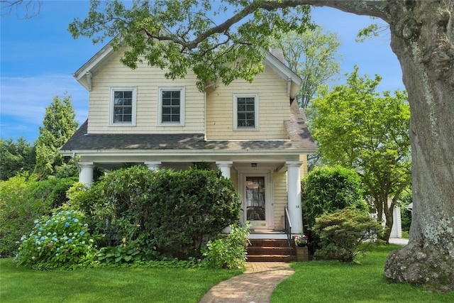 58 Garden St, Garden City, NY 11530 - view of front of home with a front lawn and a shingled roof