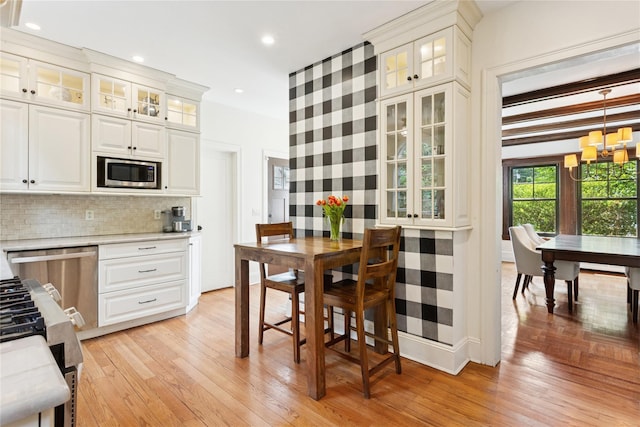 58 Garden St, Garden City, NY 11530 - kitchen featuring appliances with stainless steel finishes, light countertops, light wood-type flooring, and recessed lighting