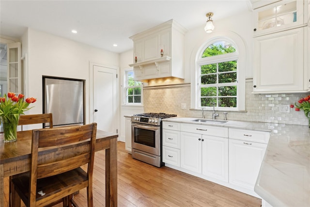58 Garden St, Garden City, NY 11530 - kitchen with stainless steel appliances, light wood finished floors, tasteful backsplash, white cabinets, and recessed lighting