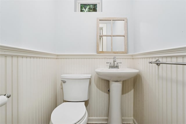 58 Garden St, Garden City, NY 11530 - half bathroom featuring toilet and a wainscoted wall