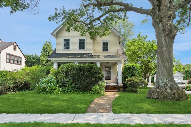 58 Garden St, Garden City, NY 11530 - view of front facade with a front lawn, covered porch, and a shingled roof