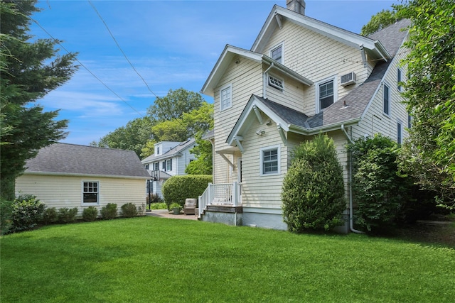 58 Garden St, Garden City, NY 11530 - back of property featuring a chimney and a lawn