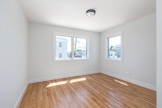 12 Pershing Pl, Island Park, NY 11558 - unfurnished room featuring light wood-style floors and baseboards