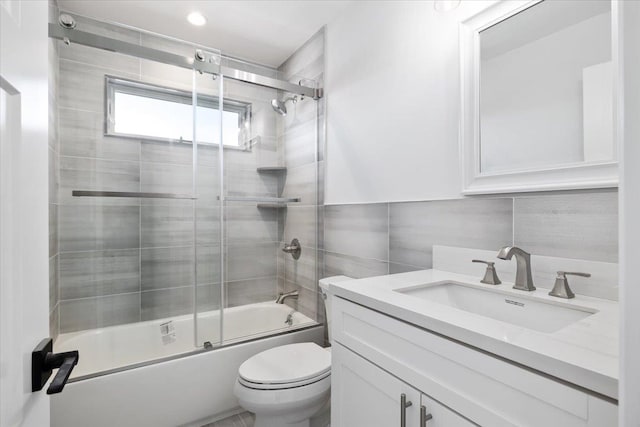 12 Pershing Pl, Island Park, NY 11558 - bathroom with vanity, shower / bath combination with glass door, tile walls, and tasteful backsplash