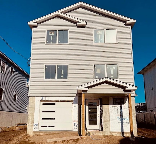 12 Pershing Pl, Island Park, NY 11558 - view of front facade with an attached garage