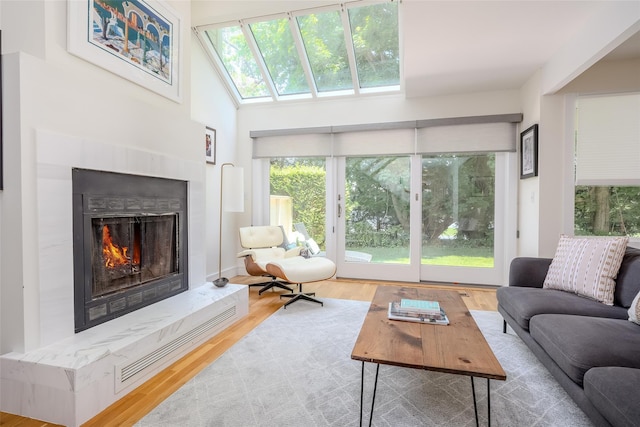 10 Head Of Pond Rd Unit 8, Water Mill, NY 11976 - living room featuring a high end fireplace, wood finished floors, and a skylight