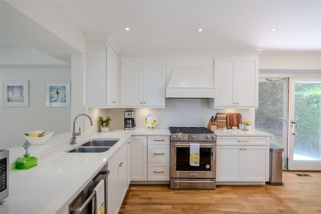 10 Head Of Pond Rd Unit 8, Water Mill, NY 11976 - kitchen featuring high end stainless steel range oven, premium range hood, a sink, light countertops, and recessed lighting
