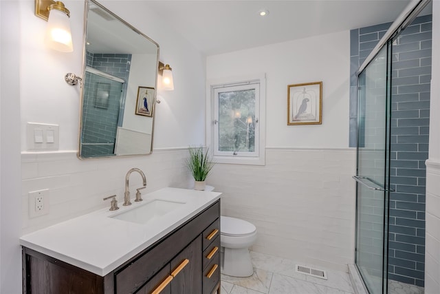 10 Head Of Pond Rd Unit 8, Water Mill, NY 11976 - full bath with tile walls, vanity, toilet, a stall shower, and a wainscoted wall