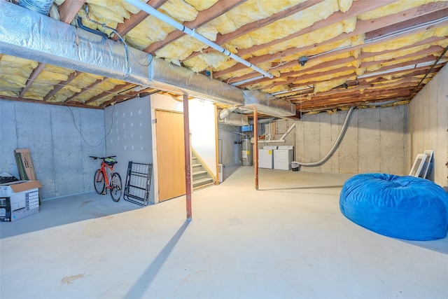 10 Head Of Pond Rd Unit 8, Water Mill, NY 11976 - unfinished basement featuring washing machine and dryer, water heater, and stairs