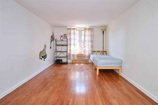 67-25 Clyde St Unit 2L, Forest Hills, NY 11375 - bedroom featuring wood finished floors and baseboards