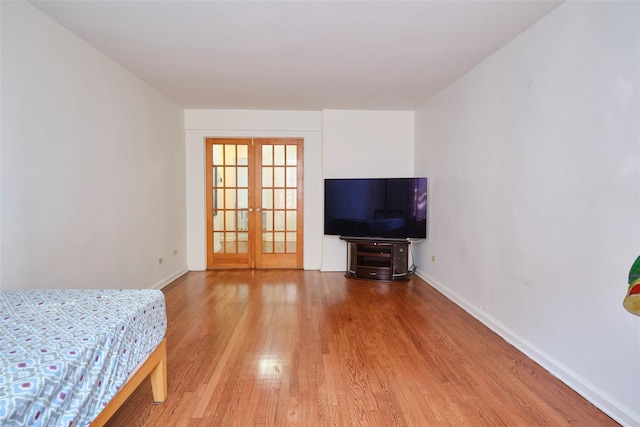 67-25 Clyde St Unit 2L, Forest Hills, NY 11375 - bedroom with french doors, wood finished floors, and baseboards