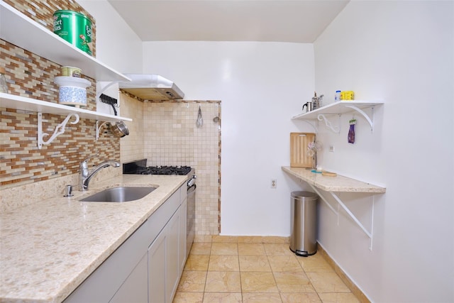 67-25 Clyde St Unit 2L, Forest Hills, NY 11375 - kitchen with open shelves, a sink, under cabinet range hood, and light stone countertops