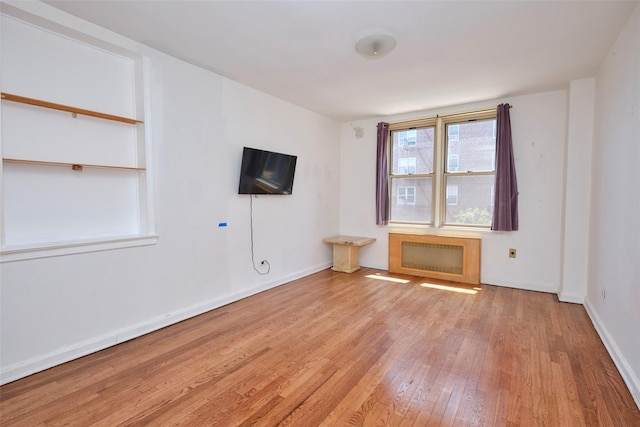 67-25 Clyde St Unit 2L, Forest Hills, NY 11375 - unfurnished room with wood-type flooring, radiator heating unit, and baseboards