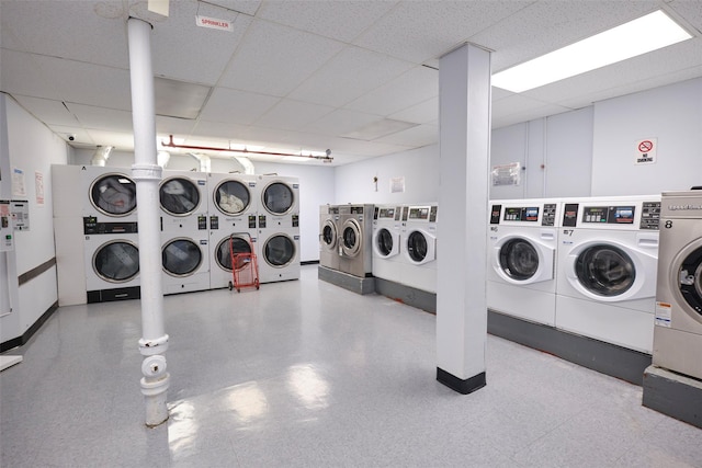 67-25 Clyde St Unit 2L, Forest Hills, NY 11375 - community laundry room with estacked washer and dryer, washer and dryer, and baseboards