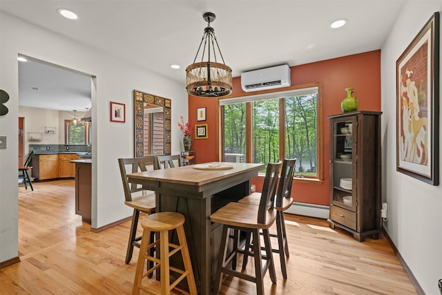 1775 Plank Rd, Forestburgh, NY 12777 - dining area with an AC wall unit, a chandelier, light wood-style floors, a baseboard heating unit, and recessed lighting