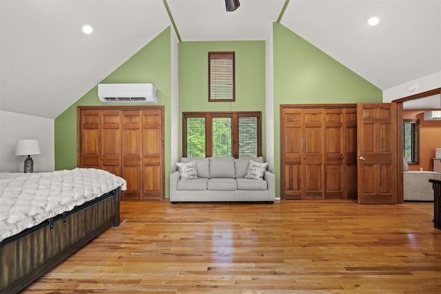 1775 Plank Rd, Forestburgh, NY 12777 - bedroom with high vaulted ceiling, light wood-style flooring, a wall mounted air conditioner, and recessed lighting