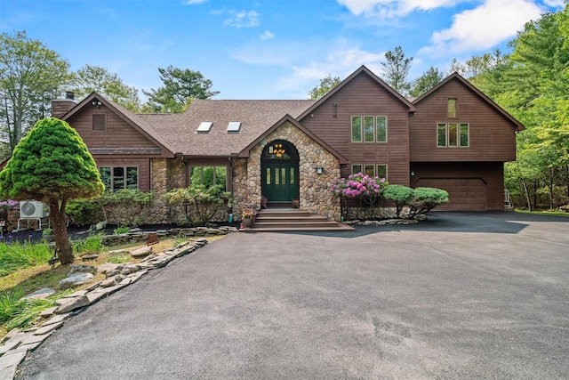 1775 Plank Rd, Forestburgh, NY 12777 - view of front facade with stone siding, a garage, a chimney, asphalt driveway, and roof with shingles