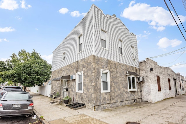 5801 59th St, Maspeth, NY 11378 - view of side of home featuring stone siding