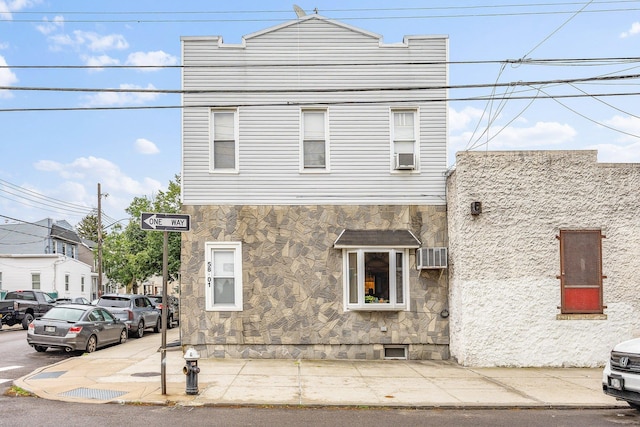 5801 59th St, Maspeth, NY 11378 - view of front of property with stone siding and a wall mounted AC