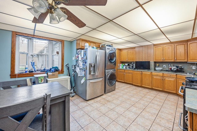 5801 59th St, Maspeth, NY 11378 - kitchen with stainless steel fridge with ice dispenser, estacked washer and dryer, a ceiling fan, light tile patterned flooring, and tasteful backsplash