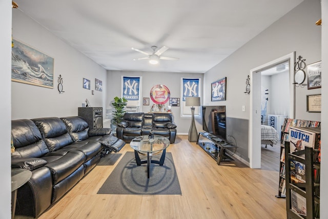 5801 59th St, Maspeth, NY 11378 - living room featuring a ceiling fan, light wood-type flooring, and baseboards