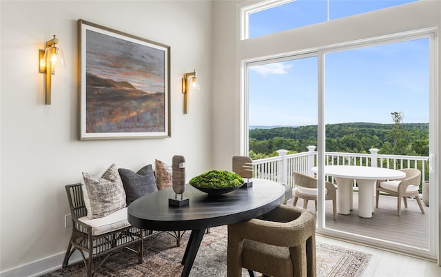 3502 Bennington Dr Unit 113, Fishkill, NY 12524 - dining space with light wood-style flooring, a wooded view, and baseboards