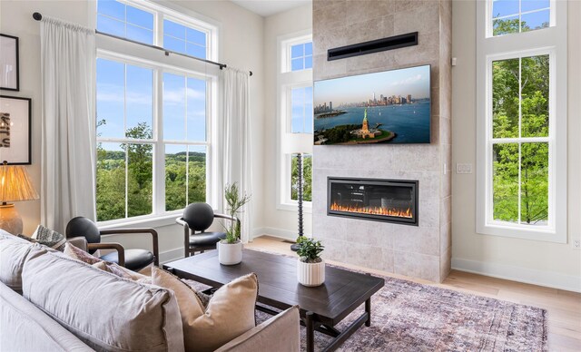 3502 Bennington Dr Unit 113, Fishkill, NY 12524 - living room with a tiled fireplace, baseboards, and wood finished floors