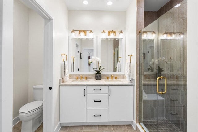 3502 Bennington Dr Unit 113, Fishkill, NY 12524 - bathroom with toilet, double vanity, a stall shower, recessed lighting, and baseboards