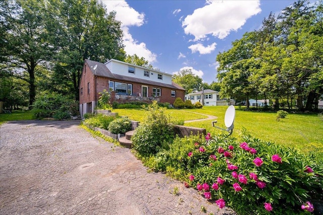 18 Gerow Ln, Cornwall, NY 12553 - view of front of house featuring brick siding, a garage, a front yard, and driveway