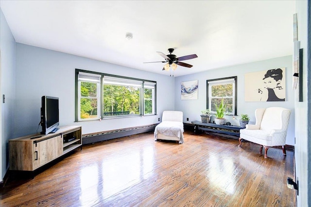 18 Gerow Ln, Cornwall, NY 12553 - living area featuring healthy amount of natural light, baseboard heating, ceiling fan, and wood finished floors