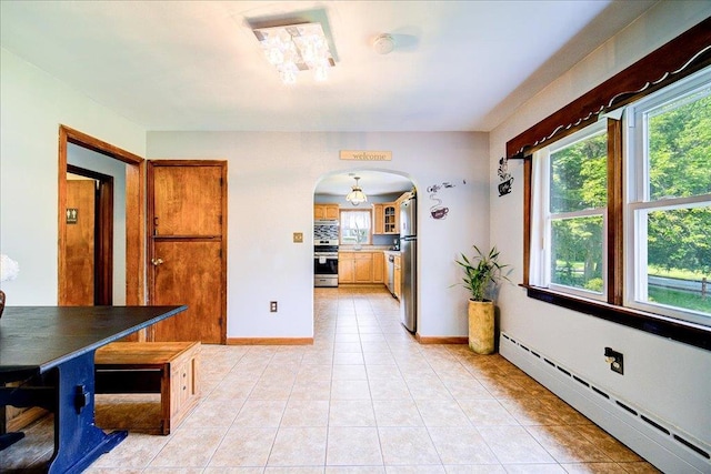 18 Gerow Ln, Cornwall, NY 12553 - dining area featuring a baseboard radiator, arched walkways, light tile patterned flooring, and baseboards
