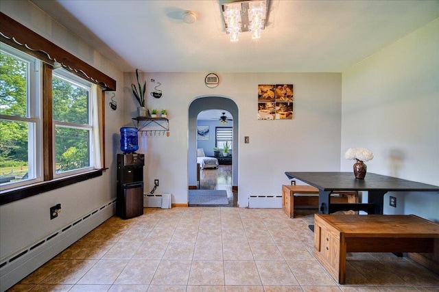 18 Gerow Ln, Cornwall, NY 12553 - dining room featuring a baseboard heating unit, arched walkways, light tile patterned flooring, and baseboard heating