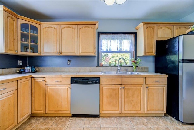 18 Gerow Ln, Cornwall, NY 12553 - kitchen with stainless steel dishwasher, freestanding refrigerator, a sink, light brown cabinets, and tile countertops