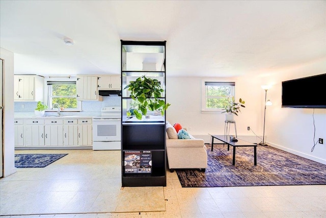 18 Gerow Ln, Cornwall, NY 12553 - living area featuring healthy amount of natural light and baseboards